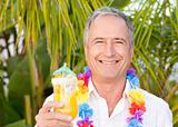 Mature man drinking a cocktail under the sun