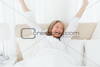 Happy woman in her bed