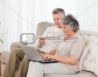Retired lovers looking at their laptop