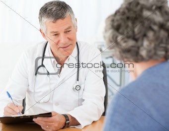 A senior doctor talking with his patient