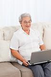 Woman looking at her laptop at home