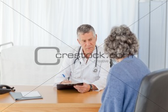 A senior doctor talking with his patient