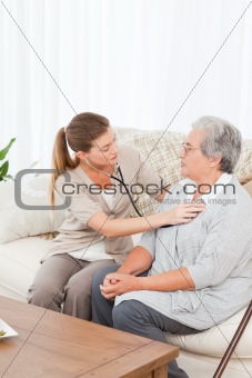 Nurse taking the heartbeat of her patient