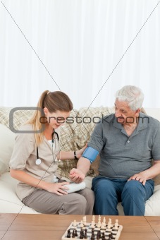 Lovely nurse helping her patient to do exercises