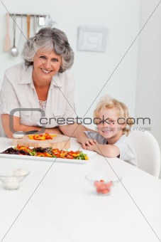 Boy and his grandmother looking at the camera 