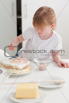 Adorable girl baking in her kitchen 