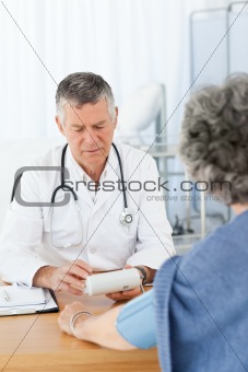 A senior doctor with his patient