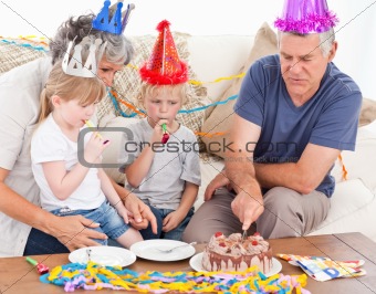 Family eating the birthday cake together