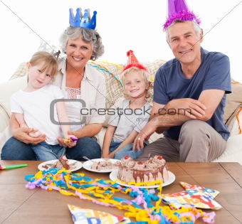 Happy family looking at the camera on a birthday