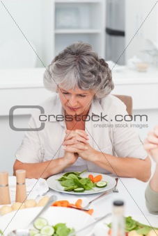 Woman praying at the table
