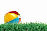 Colorful ball on green grass over white
