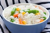 Blue bowl with cooked rice with mixed vegetable