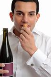 Man or wine steward sniffing wine cork