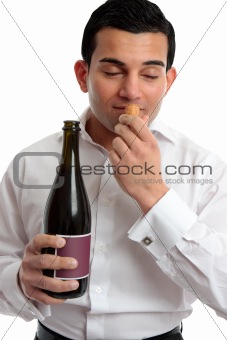 Man sniffing wine cork