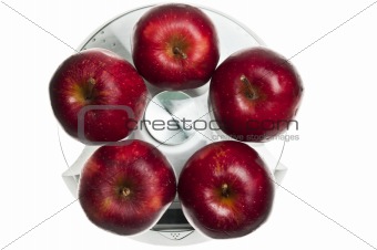 Red apples on food scale