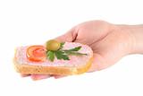 hand holding toast with fish caviar cream