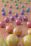 Colorful marble balls on a parquet floor