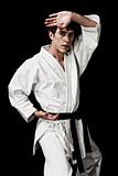 Karate male fighter young high contrast on black background.