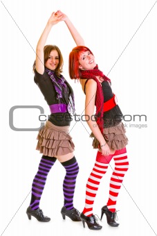 Two cheerful young girlfriends dancing for fun 
