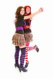 Two cheerful young girlfriends dancing for fun 
