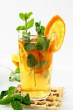 Tea with orange and branches of mint