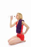 Pretty fitness woman drinking water after training exercises.