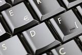 Closeup of laptop keyboard. Emphasis on »euro« button