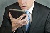 Businessman Looks At Tablet With Despair
