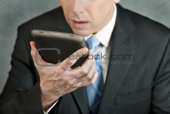 Businessman Looks At Tablet With Despair