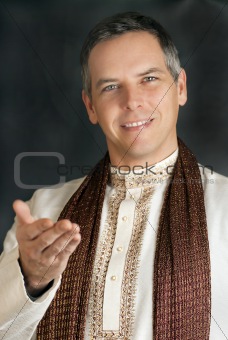 Man in Traditional Indian Clothing Gestures To Camera