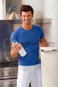 man in the kitchen with a bottle of milk