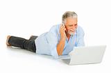 elderly man using laptop and mobile