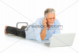 elderly man using laptop and mobile
