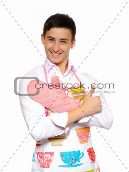 Young smiling man in apron preparing to cook romantic dinner