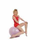 Pretty sporty fitness woman doing exercise with pilates ball.