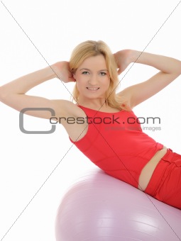 Pretty sporty fitness woman doing abs exercise with pilates ball