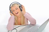 Pretty young girl listening and singing with headphones