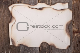 Old burnt paper on wood texture