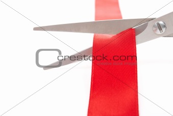 Scissors cutting red ribbon 