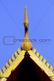 detail of ornately decorated temple roof in bangkok, thailand 
