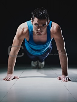 Man doing push-ups on black background