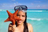 latin tourist girl holding starfish tropical beach