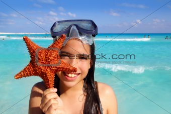 latin tourist girl holding starfish tropical beach