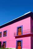 Mexican pink house facade  wooden doors