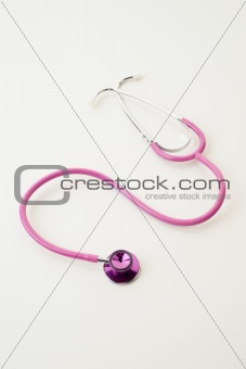 pink stethoscope on white