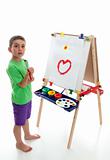 Young child standing at art easel