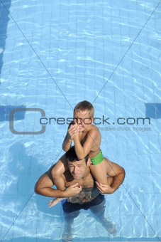 happy father and son at swimming pool