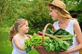Young woman and daughter with fresh vegetable