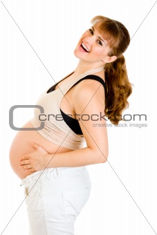 Happy pregnant woman holding her tummy isolated on white
