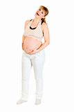 Laughing pregnant woman holding her tummy isolated on white
